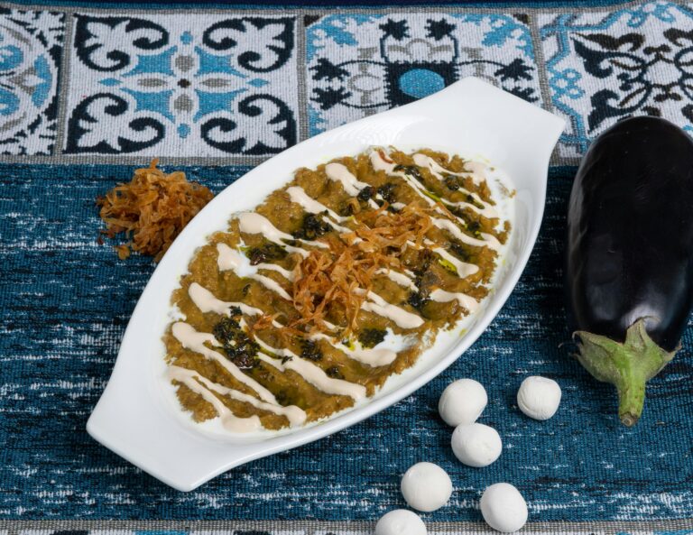Delicious eggplant dish topped with creamy sauce and herbs, perfect for gourmet food lovers.