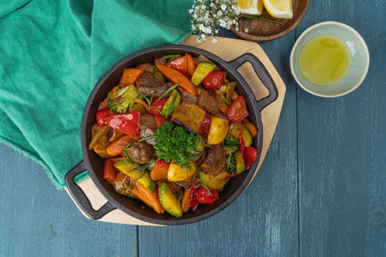 Delicious stir-fried vegetables and beef in a black skillet top view, perfect for colorful cuisine inspiration.